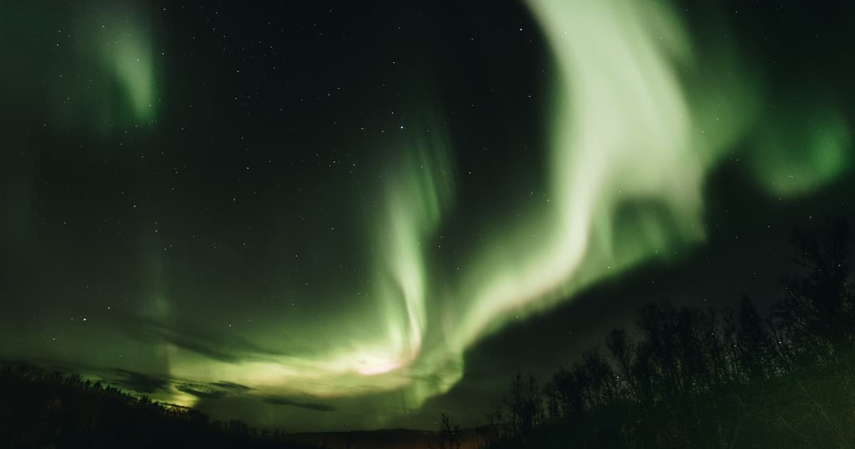 Aurora borealis reflected in the frozen waters of Lake Inari, Finland