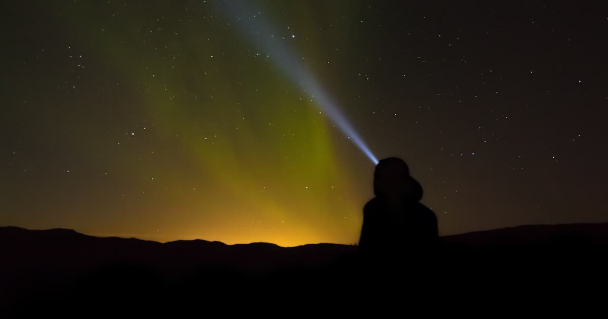 Northern lights illuminate the snowy wilderness outside Rovaniemi, Finnish Lapland